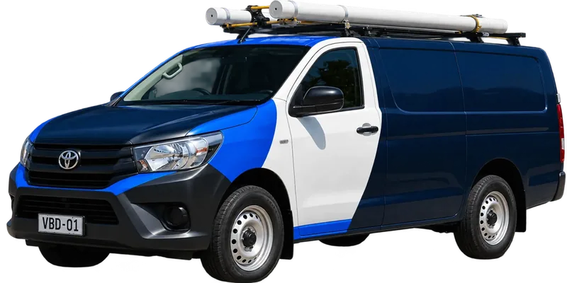 A licensed the North Shore plumbing van loaded with pipe on the roof rack
